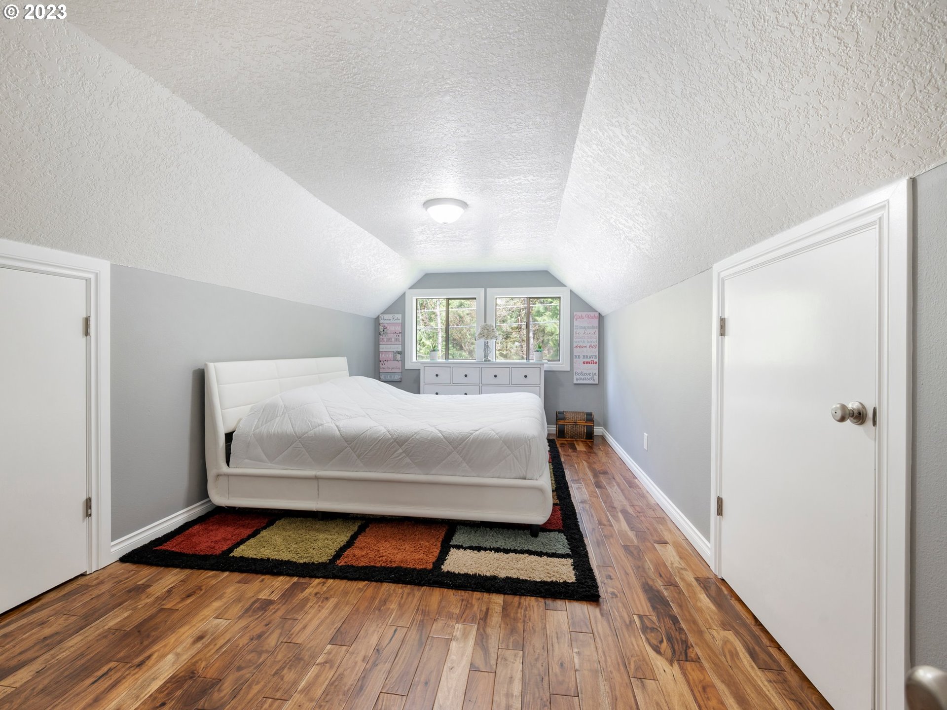 65353 East Timberline Drive Rhododendron, OR 97049 - Photo 21 of 34 a bed sitting in a bedroom next to a window