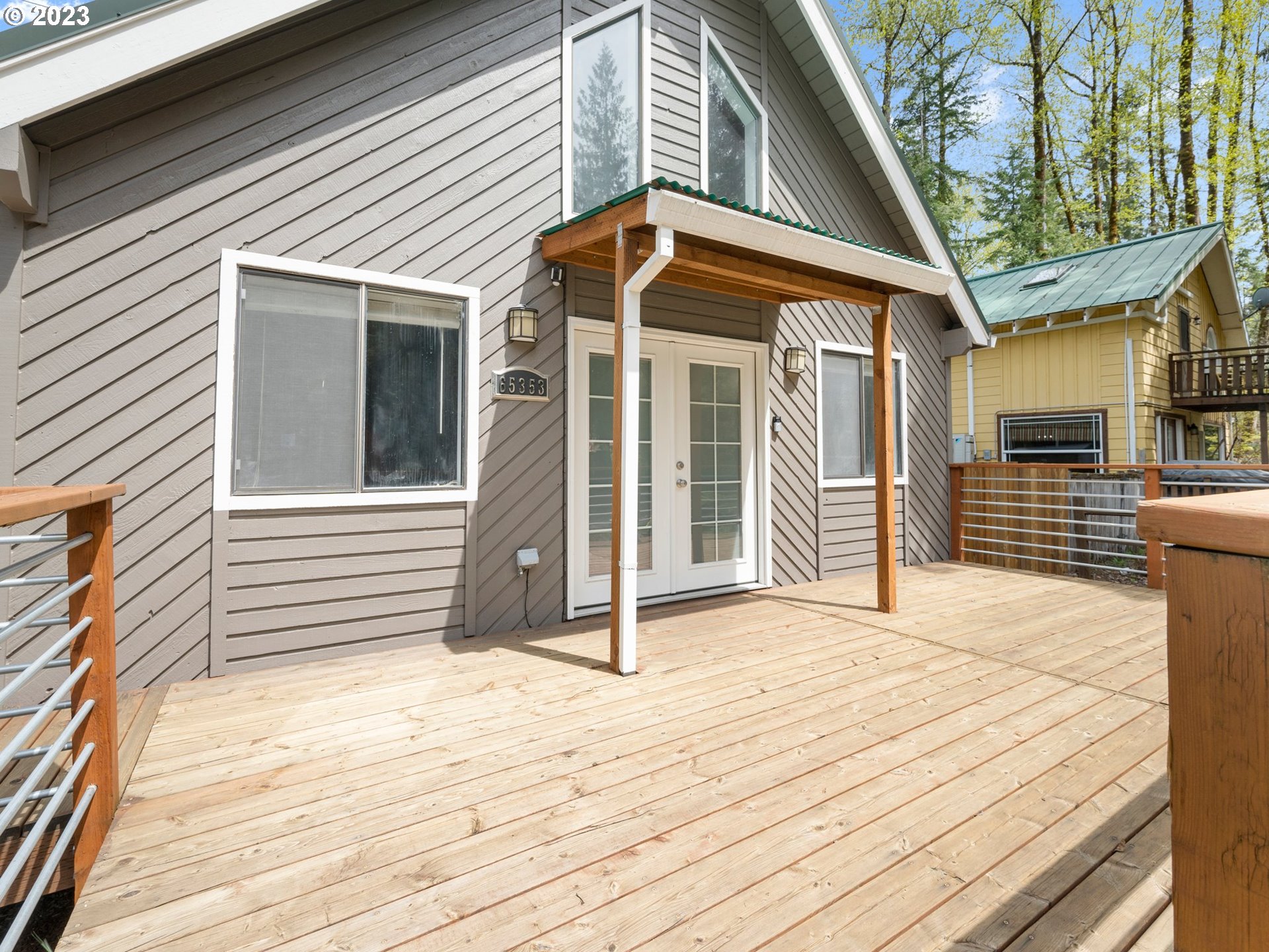 65353 East Timberline Drive Rhododendron, OR 97049 - Photo 3 of 34 a front view of a house with a porch