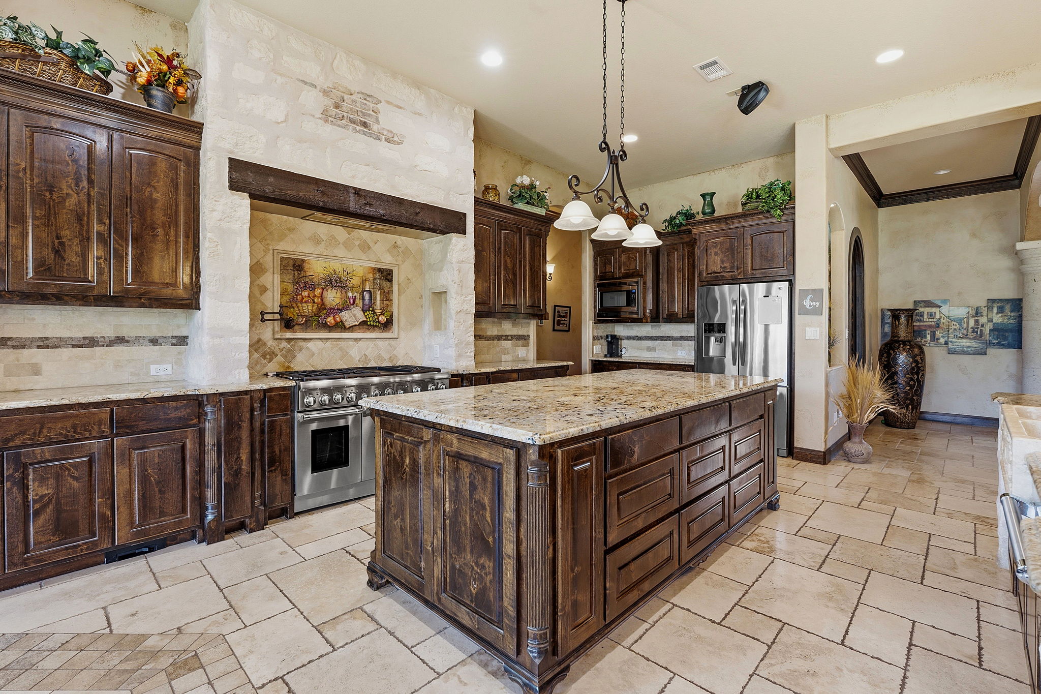816 Brave Face Street Leander, TX 78641 - Photo 10 of 40 Culinary aspirations find their home in this well-appointed kitchen, featuring a generous island and professional-grade appliances.