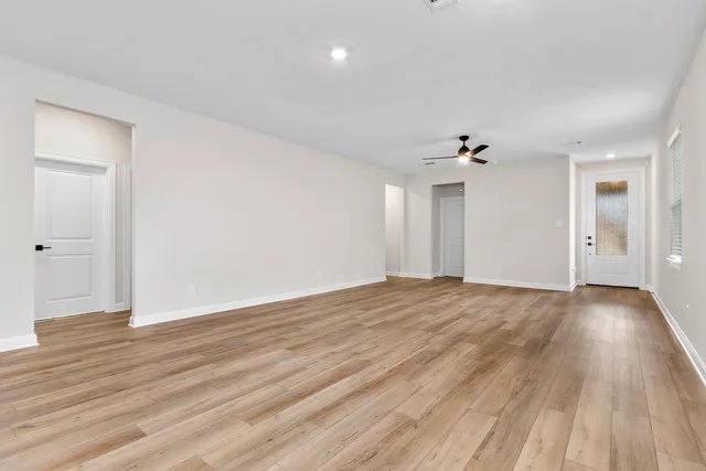 a view of an empty room and wooden floor