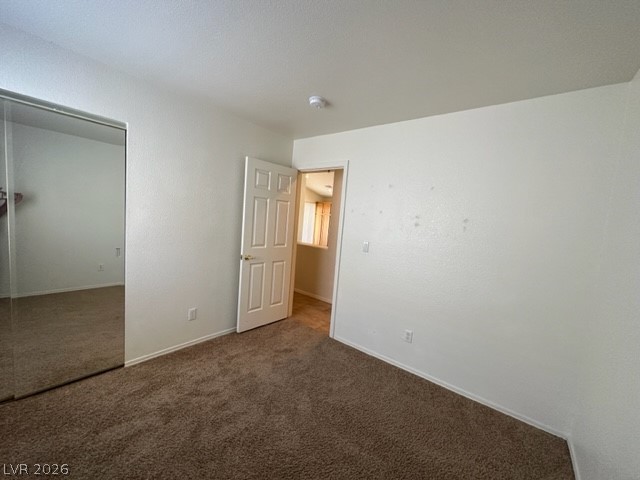285 Spring Palms Street Henderson, NV 89012 - Photo 17 of 38 Unfurnished bedroom featuring a closet, carpet, and baseboards