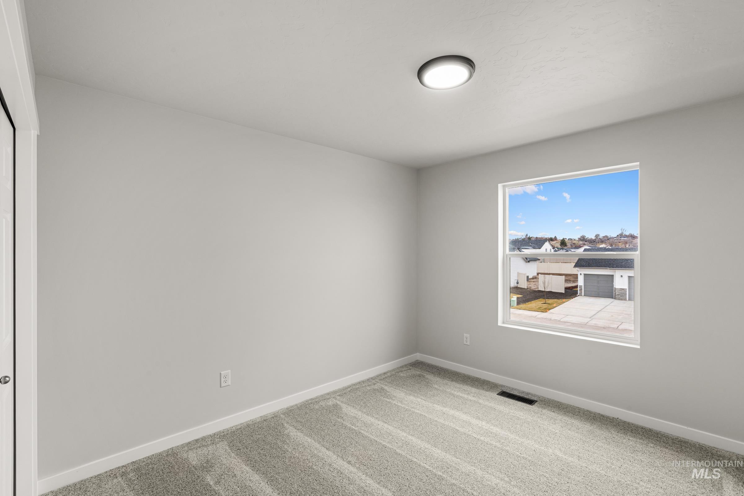13693 Redway Court Caldwell, ID 83607 - Photo 17 of 25 Unfurnished room featuring baseboards and light carpet