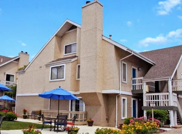 a front view of a building with umbrellas