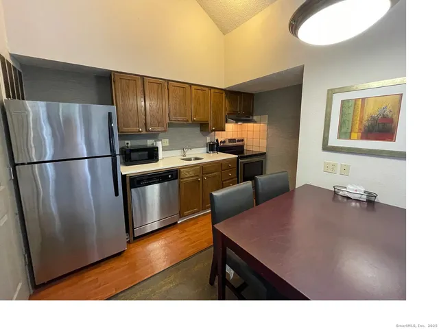 a kitchen with refrigerator cabinets and wooden floor