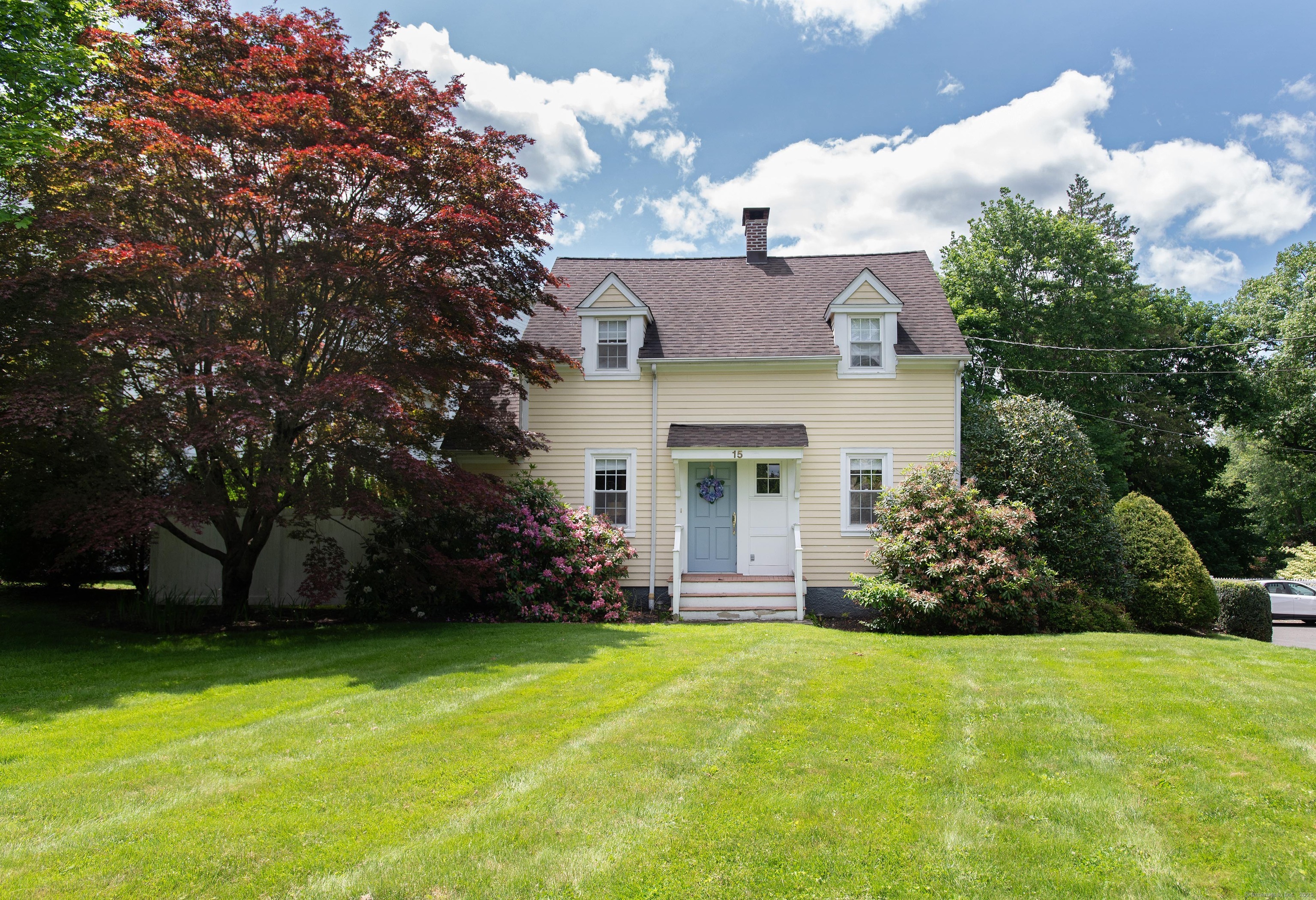 a front view of a house with a garden