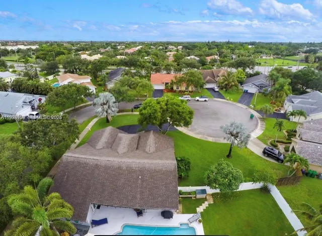 an aerial view of residential houses with outdoor space and street view