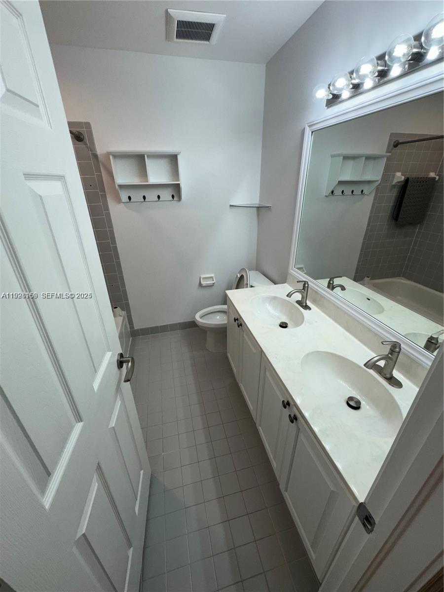 8965 Southwest 59th Court Cooper City, FL 33328 - Photo 12 of 34 a en suite bathroom with a vanity sink and a mirror