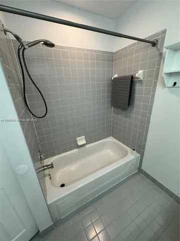 a bathroom with a white bath tub and a shower