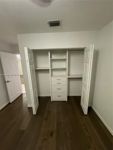 a view of an empty room with a fireplace