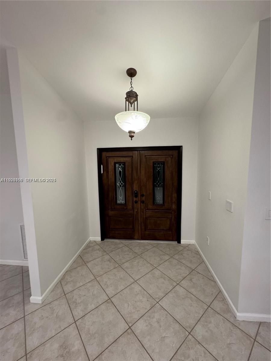 8965 Southwest 59th Court Cooper City, FL 33328 - Photo 23 of 34 a bedroom with a chandelier and closet