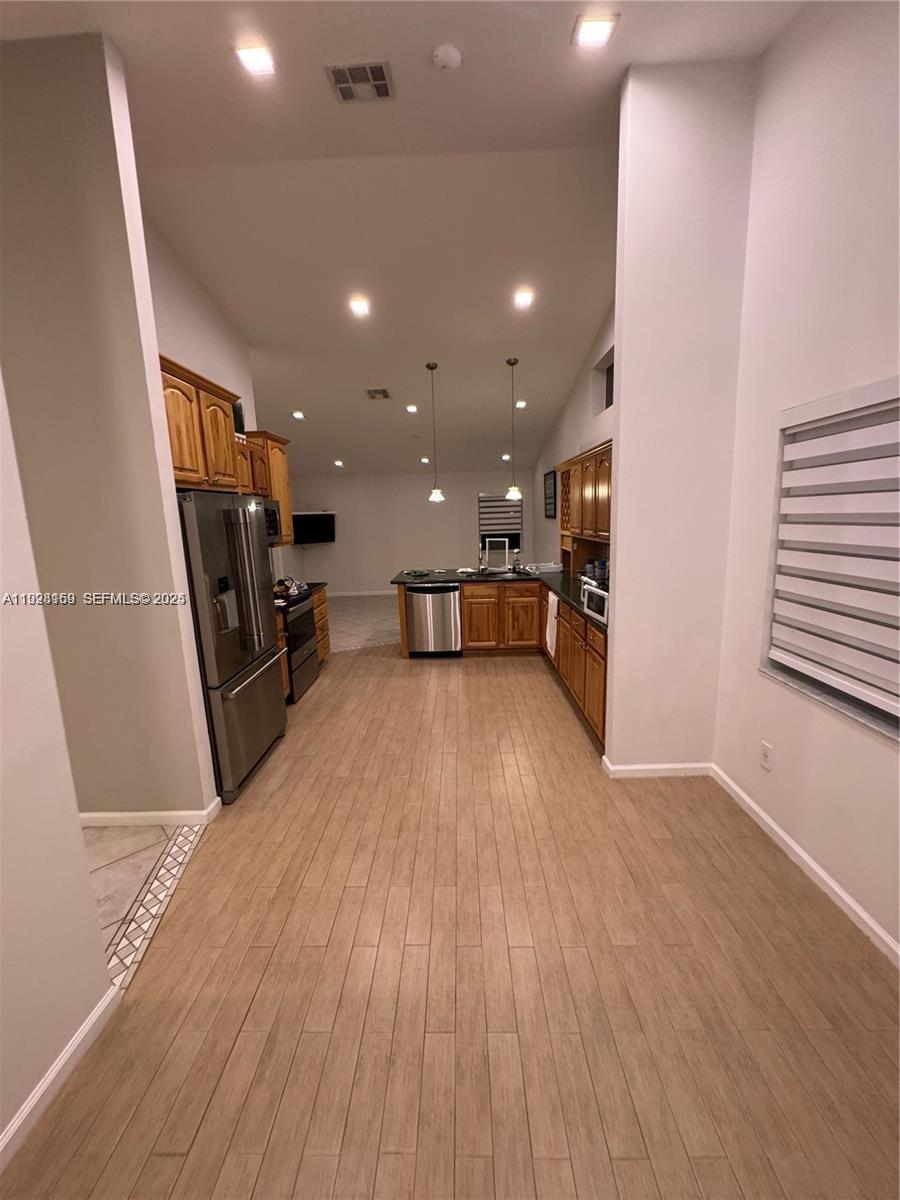 8965 Southwest 59th Court Cooper City, FL 33328 - Photo 29 of 34 a view of a kitchen with a sink and a refrigerator