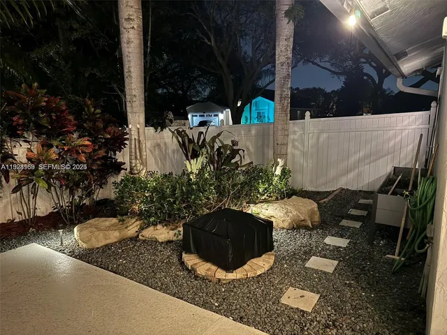 a view of a backyard with plants and a patio