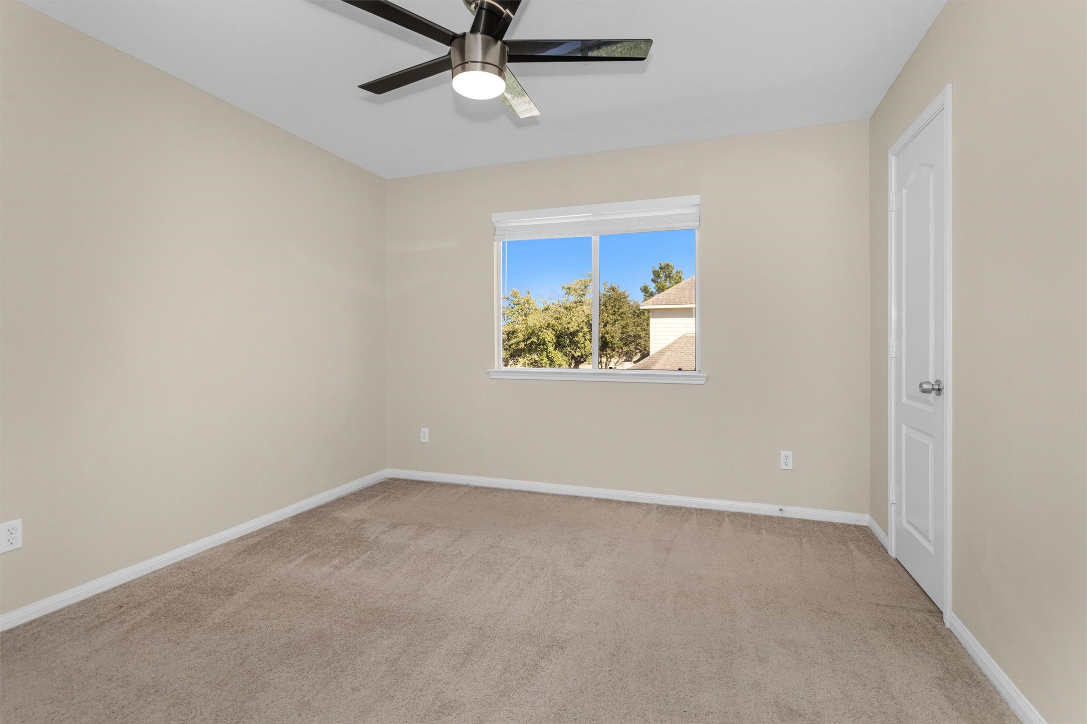 29710 Legends Ranch Court Spring, TX 77386 - Photo 17 of 20 an empty room with a window and a ceiling fan