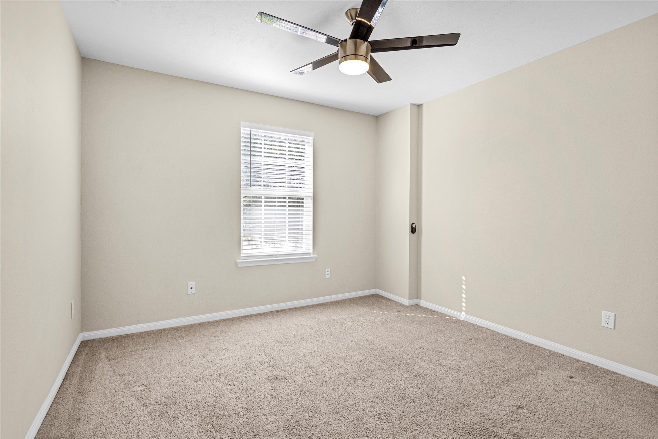 29710 Legends Ranch Court Spring, TX 77386 - Photo 19 of 20 an empty room with a window and a fan