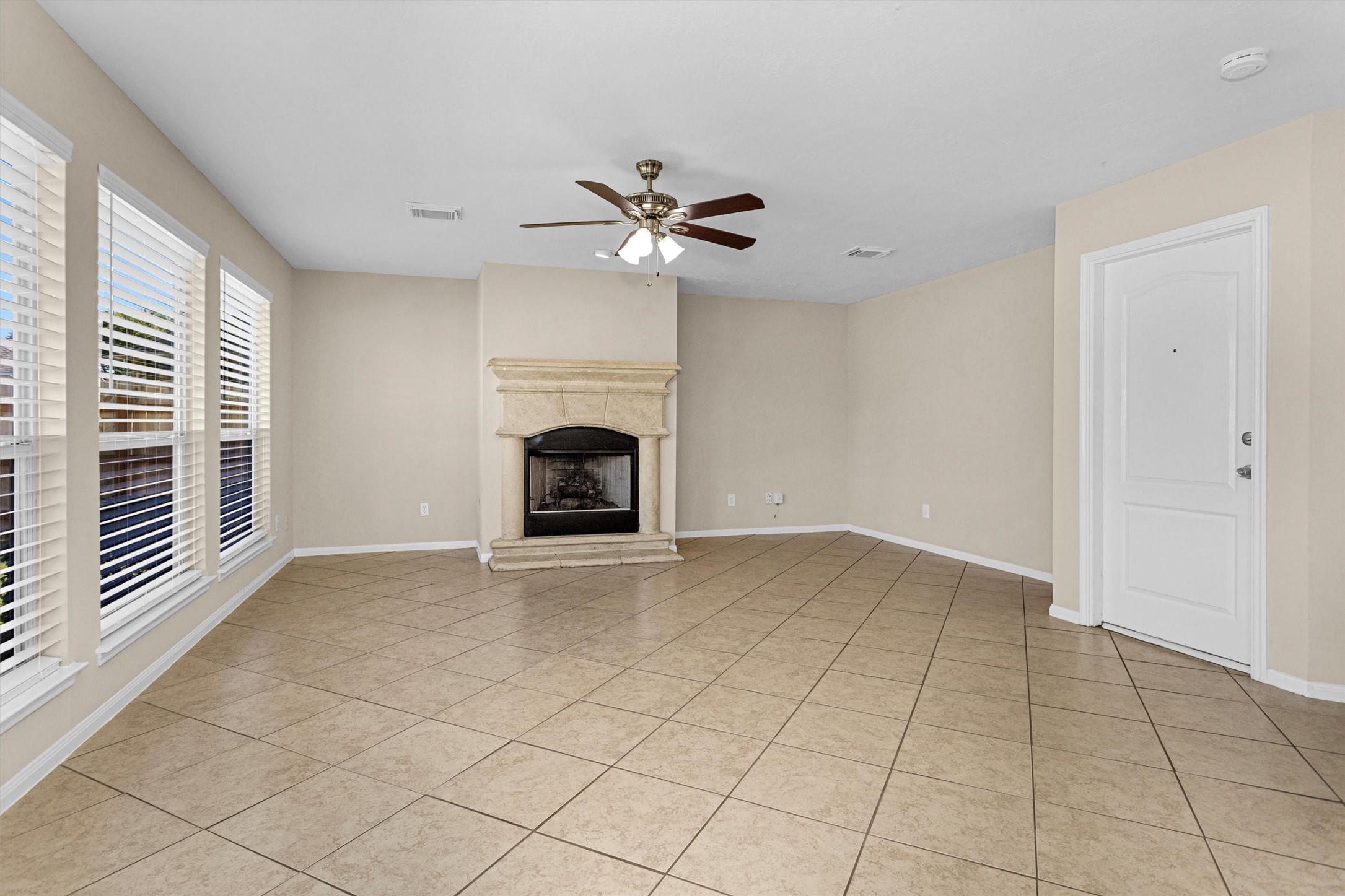 29710 Legends Ranch Court Spring, TX 77386 - Photo 4 of 20 an empty room with windows and fireplace