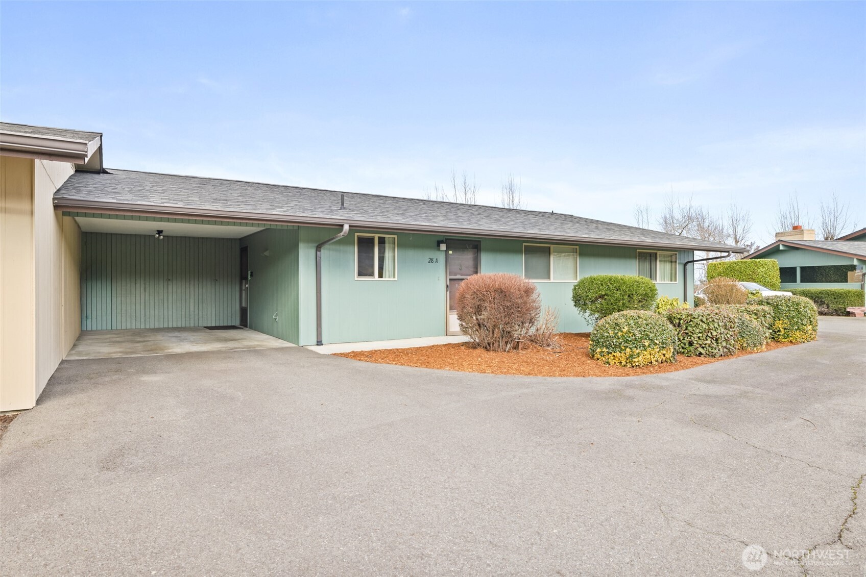 1301 South 3rd Avenue, Unit 28A Sequim, WA 98382 - Photo 1 of 40 a view of an house with backyard and bushes