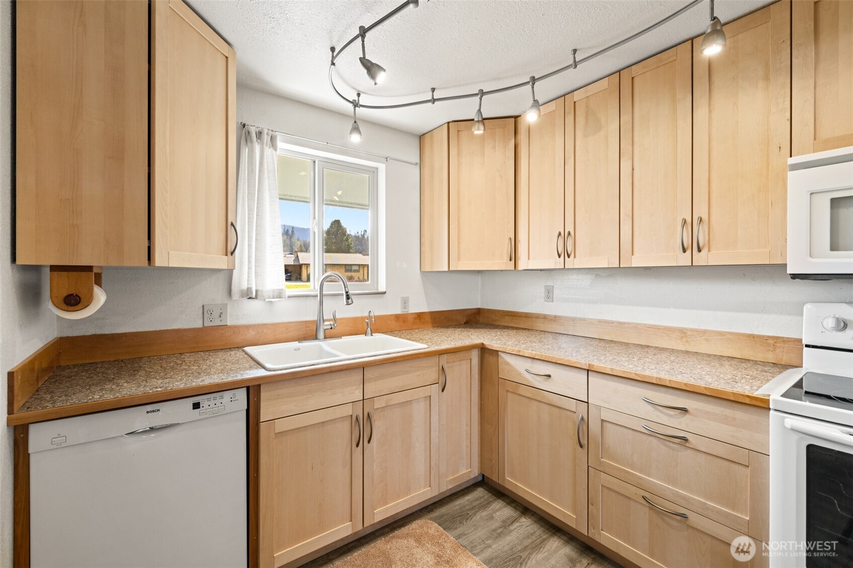1301 South 3rd Avenue, Unit 28A Sequim, WA 98382 - Photo 12 of 40 a kitchen with a sink and cabinets