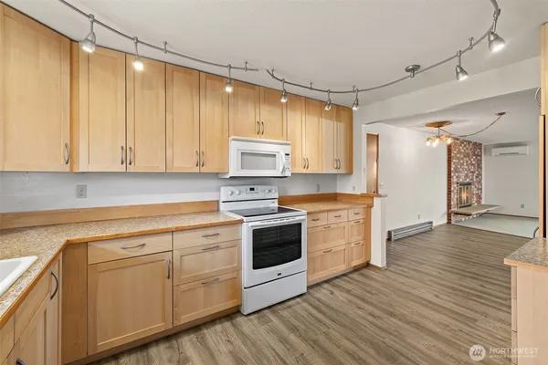 a kitchen with white cabinets and white appliances