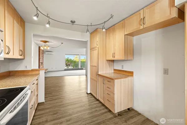 a kitchen with stainless steel appliances a stove a sink and cabinets