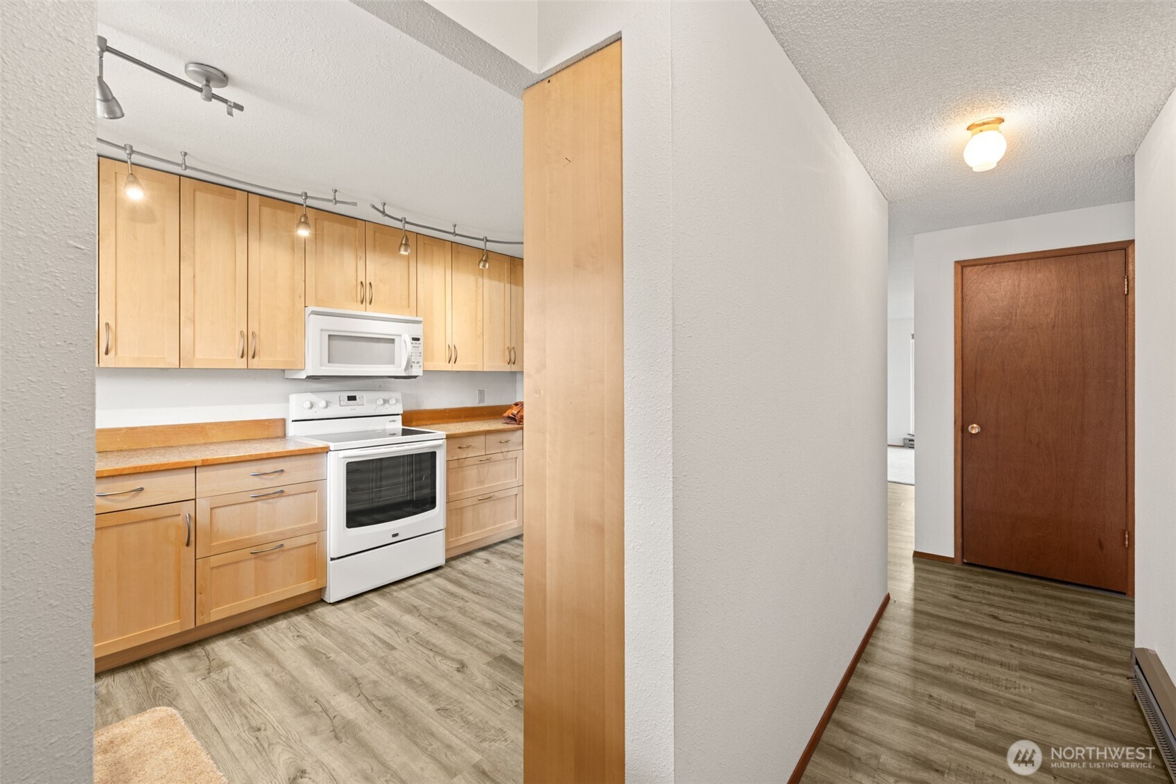 1301 South 3rd Avenue, Unit 28A Sequim, WA 98382 - Photo 16 of 40 a kitchen with white cabinets and white appliances