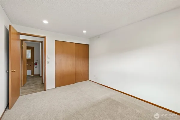 a bathroom with a granite countertop sink a toilet and a mirror