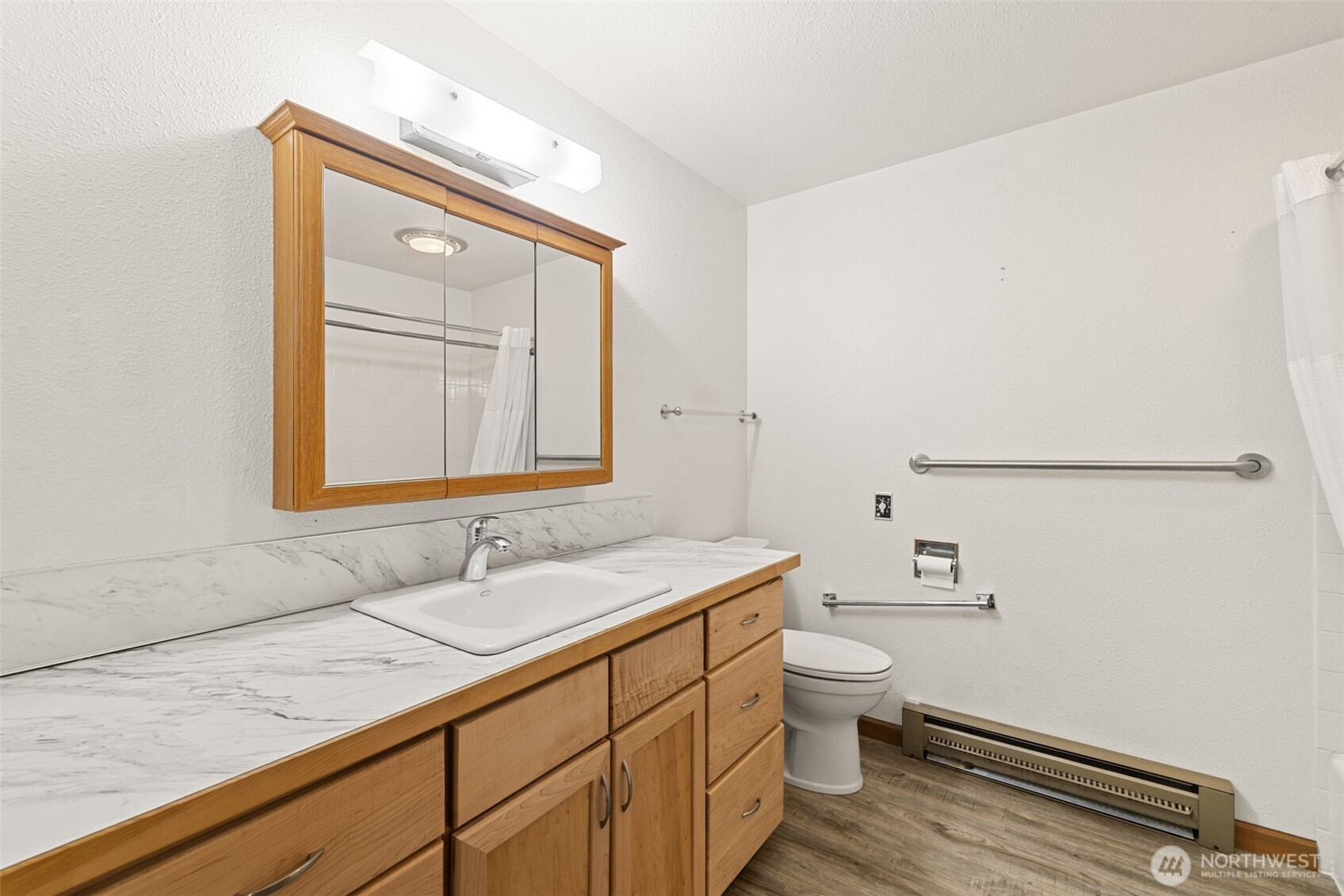 1301 South 3rd Avenue, Unit 28A Sequim, WA 98382 - Photo 20 of 40 a bathroom with a granite countertop sink a toilet and a mirror
