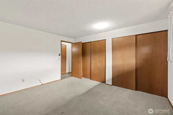 a view of hallway with stairs and wooden floor