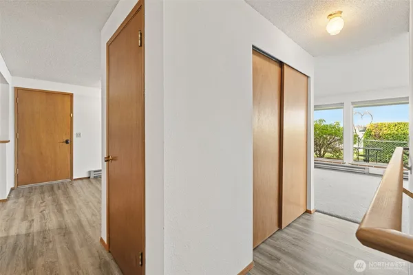a view of hallway with wooden floor