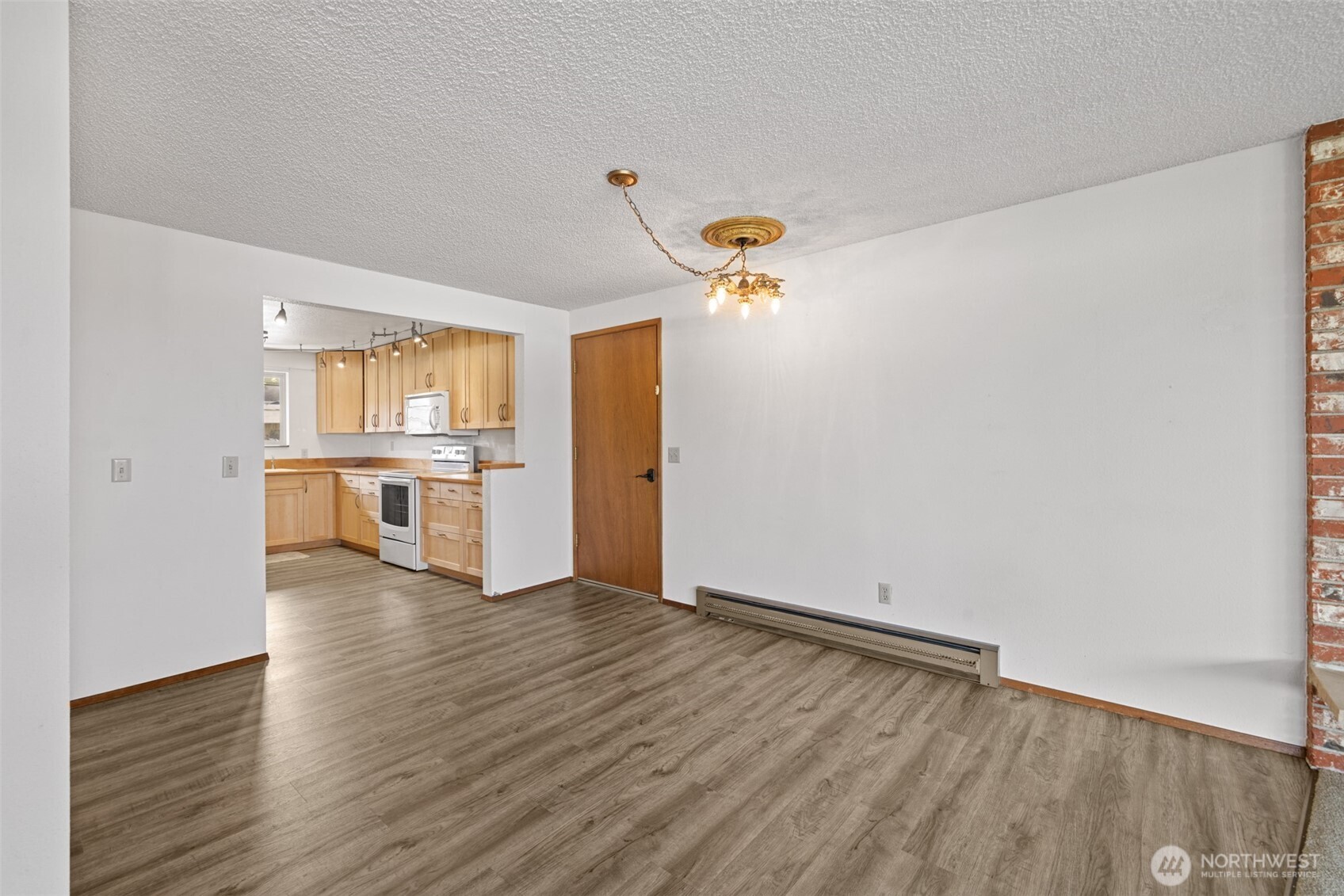 1301 South 3rd Avenue, Unit 28A Sequim, WA 98382 - Photo 7 of 40 wooden floor in an empty room with a kitchen