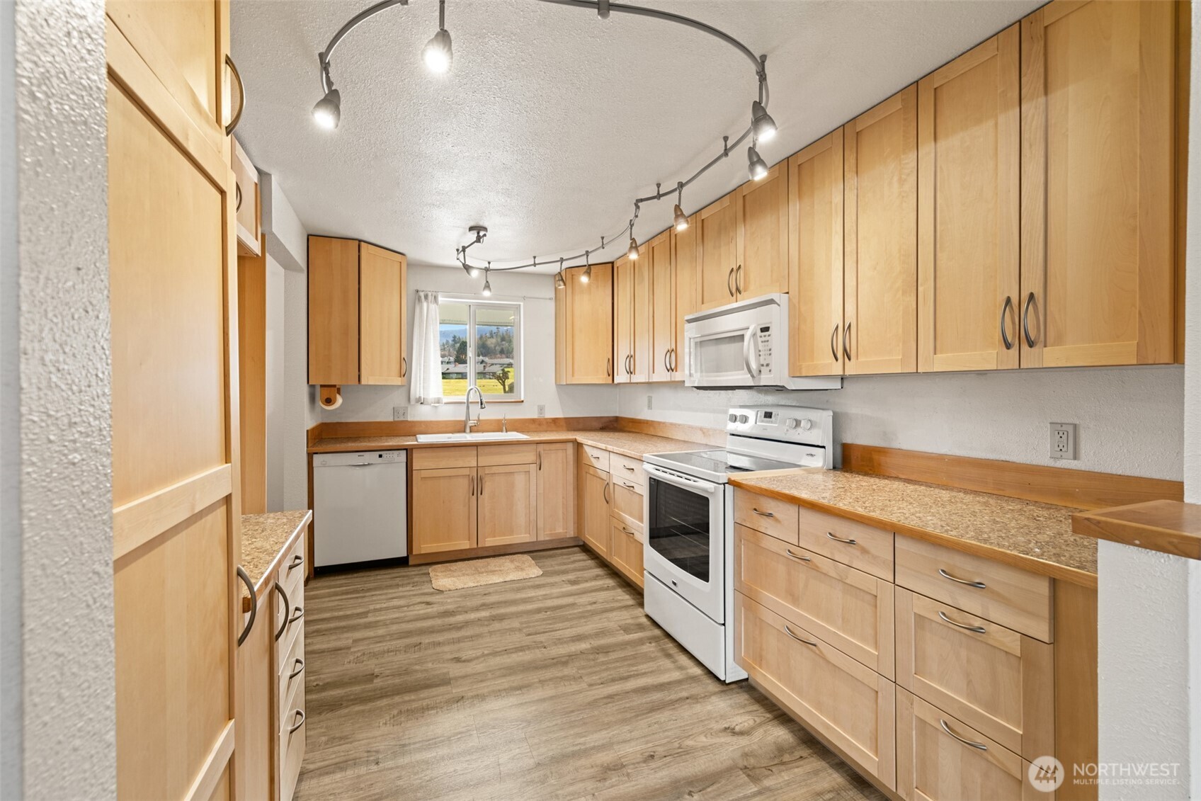 1301 South 3rd Avenue, Unit 28A Sequim, WA 98382 - Photo 10 of 40 a kitchen with granite countertop white cabinets and white appliances