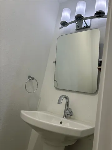 a bathroom with a sink and mirror