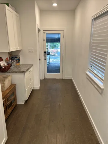 a hallway with a sink and cabinets