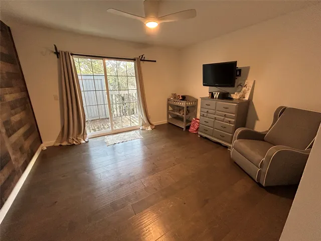a view of a livingroom with furniture and a flat screen tv