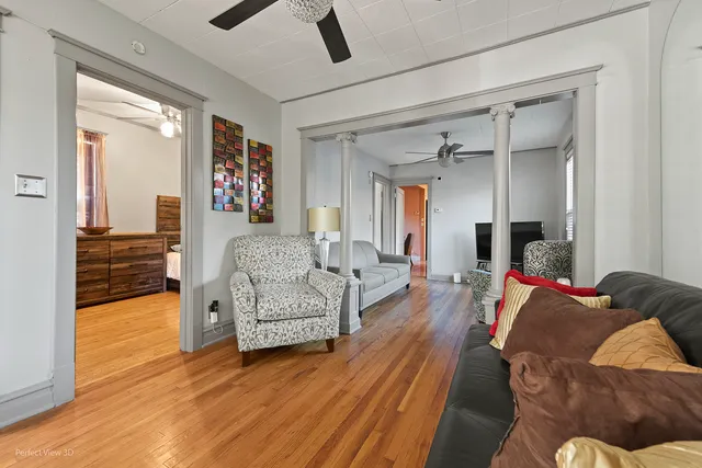a living room with furniture and a wooden floor