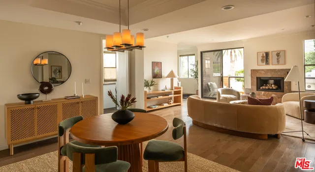 a living room with furniture a fireplace and a chandelier