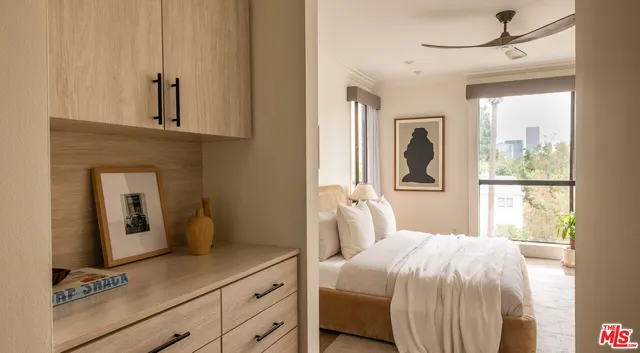 a bedroom with a bed and a mirror on the dresser