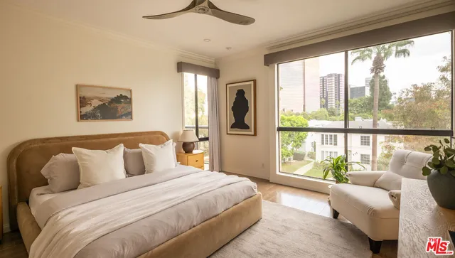 a bedroom with a large bed and a large window