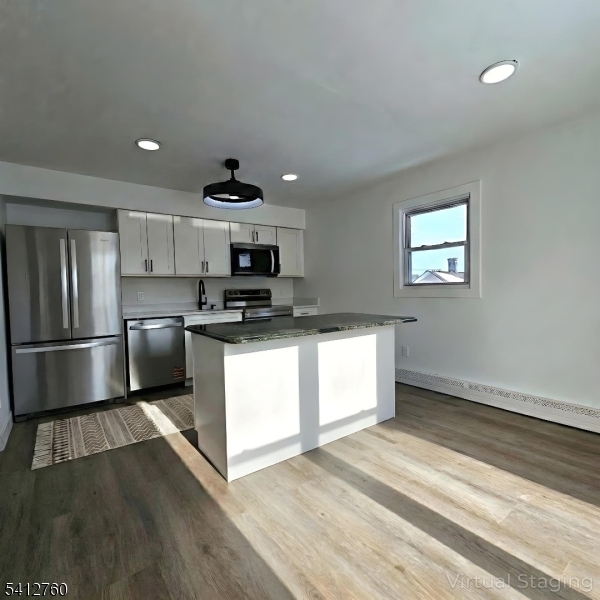 8 Berry Street, Unit 2 Dover, NJ 07801 - Photo 15 of 19 a kitchen with stainless steel appliances kitchen island granite countertop a stove a sink and a refrigerator