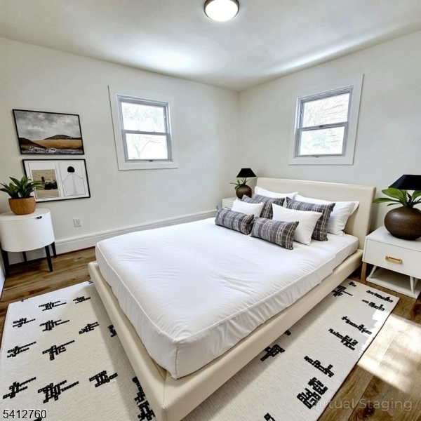 8 Berry Street, Unit 2 Dover, NJ 07801 - Photo 5 of 19 a bedroom with a bed a mirror and a window