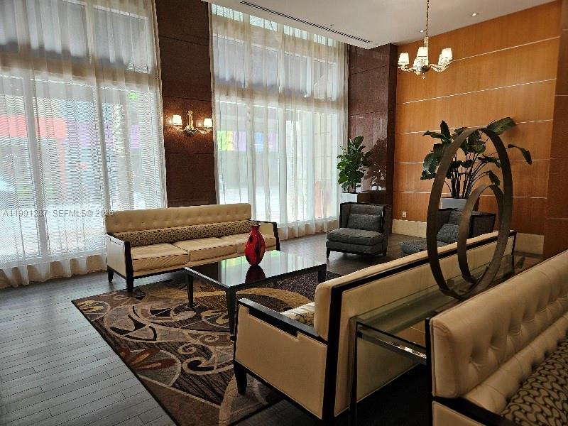 253 Northeast 2nd Street, Unit 905 Miami, FL 33132 - Photo 14 of 20 a living room with furniture and a potted plant