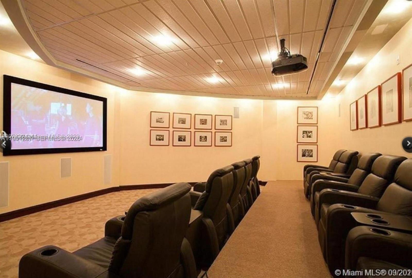 253 Northeast 2nd Street, Unit 905 Miami, FL 33132 - Photo 18 of 20 a living room with patio furniture and a flat screen tv