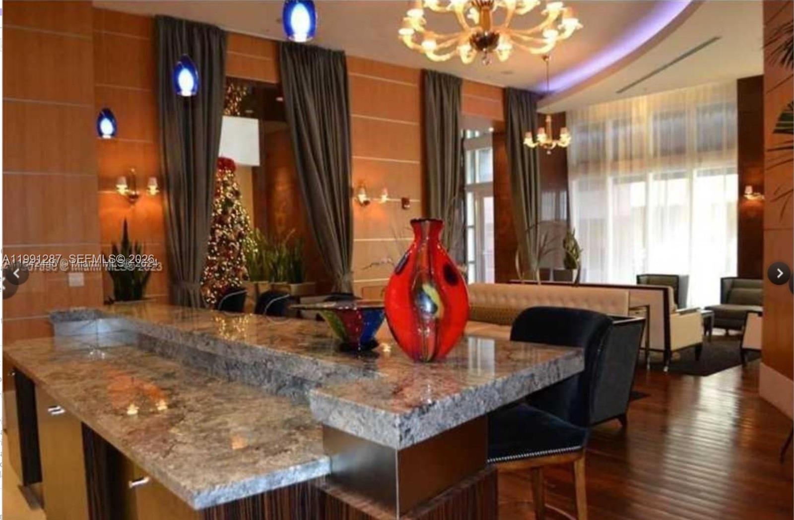 253 Northeast 2nd Street, Unit 905 Miami, FL 33132 - Photo 19 of 20 an outdoor kitchen with a table and chairs