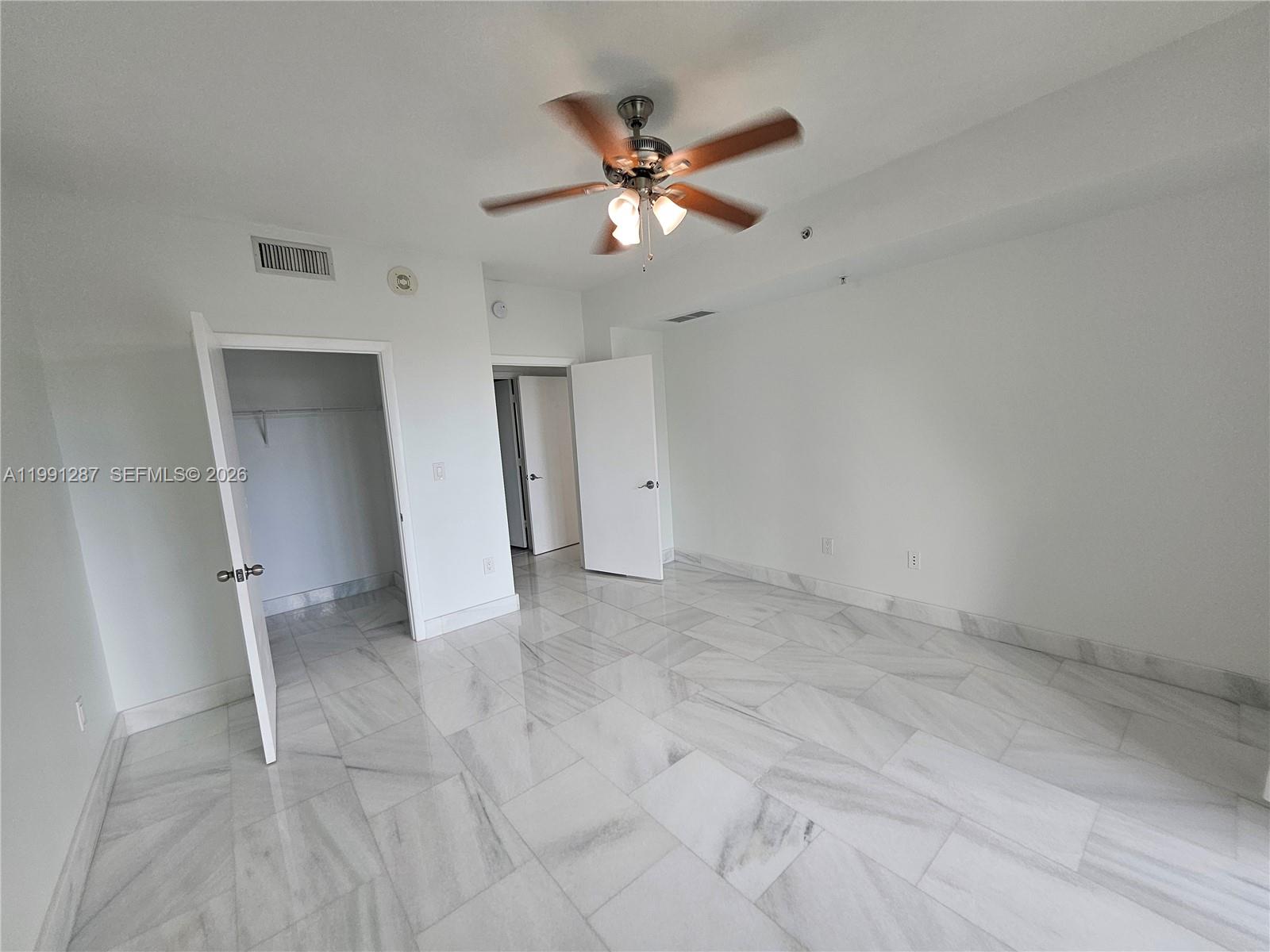 253 Northeast 2nd Street, Unit 905 Miami, FL 33132 - Photo 8 of 20 wooden floor in an empty room with a ceiling fan