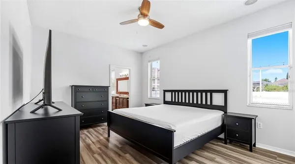 a bedroom with a bed and a chandelier