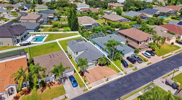 an aerial view of residential houses with outdoor space