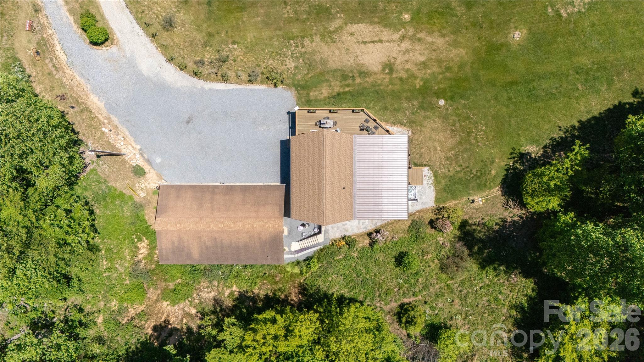93 Franklin Crest Road Spruce Pine, NC 28777 - Photo 19 of 47 an aerial view of a house with a yard and garden