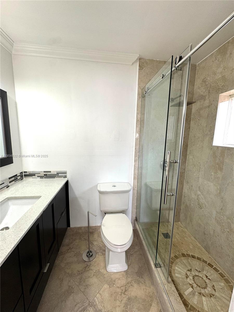 7870 West 29th Way, Unit 201 Hialeah, FL 33018 - Photo 15 of 18 a bathroom with a granite countertop sink toilet and shower
