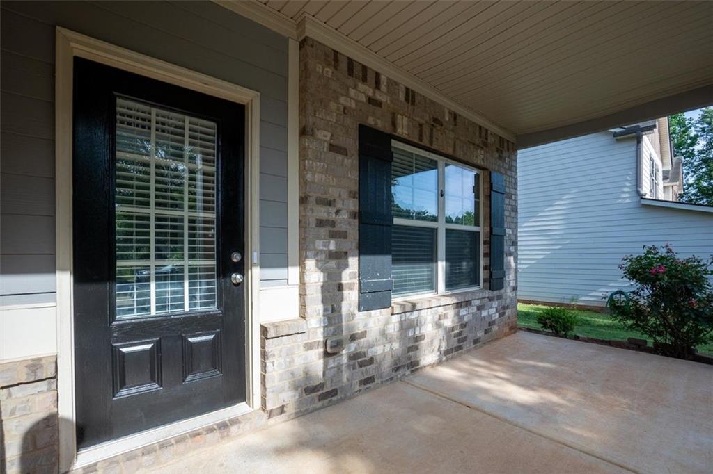 9120 Alden Drive Locust Grove, GA 30248 - Photo 11 of 39 a front view of a house with a yard