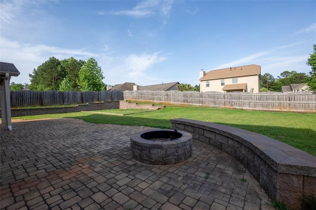 9120 Alden Drive Locust Grove, GA 30248 - Photo 12 of 39 a view of a backyard with a garden and fire pit