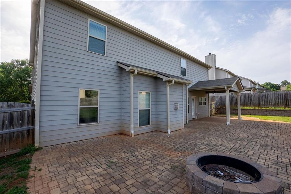 9120 Alden Drive Locust Grove, GA 30248 - Photo 13 of 39 a view of a house with a small yard and a large tree